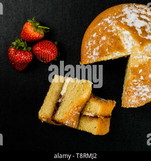 Victoria Sponge Cake With Fresh Strawberries on a Black Table Top Background Stock Photo