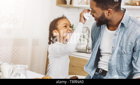 Happy afro man and his daughter having breakfast Stock Photo