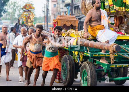 Madurai, India - August 23, 2018: Devotees pulling chariots with deities statues to Meenakshi Amman temple for the dormition ceremony Stock Photo