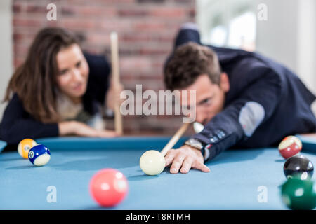 Fashionable couple playing snooker. Stock Photo