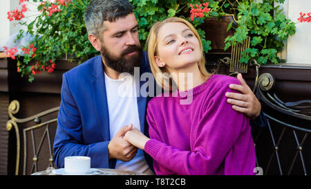 Pleasant family weekend. Married lovely couple relaxing together. Travel and vacation. Explore cafe and public places. Couple cuddling cafe terrace. Couple in love sit cafe terrace enjoy coffee. Stock Photo