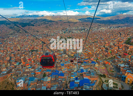 Cityscape of La Paz city and the new public transport system of Cable Cars named Teleferico, the snowcapped Andes mountain peaks in the back, Bolivia. Stock Photo