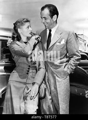 HUMPHREY BOGART and LAUREN BACALL 1945 candid newlyweds with gold whistle publicity still Warner Bros. Stock Photo