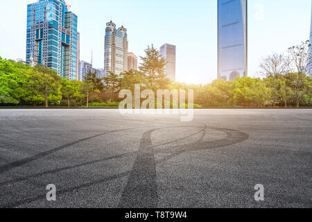 Asphalt race track and modern commercial office building in Shanghai Stock Photo