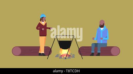 couple of tourists hikers man woman cooking meals in bowler boiling pot at campfire hiking camping concept african american travelers on hike Stock Vector