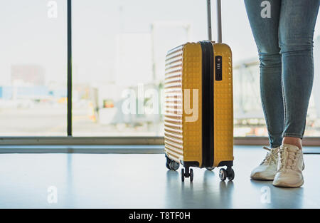 Woman with luggage in the airport. Stock Photo