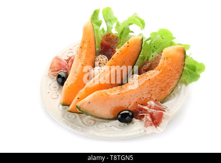 Plate with delicious melon and prosciutto on white background Stock Photo