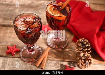 Glasses of delicious mulled wine on wooden table Stock Photo