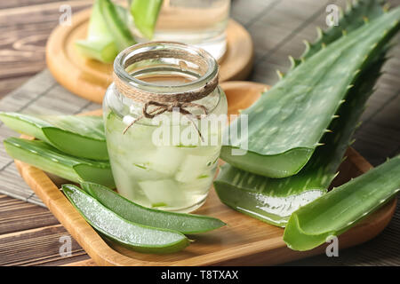 Jar of aloe vera juice on wooden tray Stock Photo