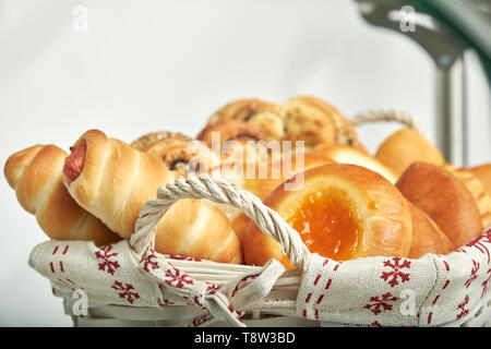 Assorted bakery products in a wicker basket. Delicious dessert Stock Photo