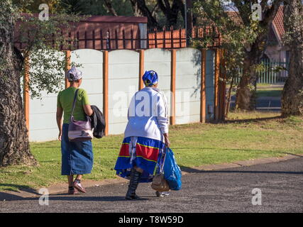 Johannesburg, South Africa - unidentified black women walk home in the afternoon from their jobs as domestic workers in the city