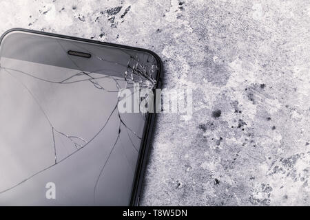 Broken glass on the smartphone screen with copy space, top view Stock Photo