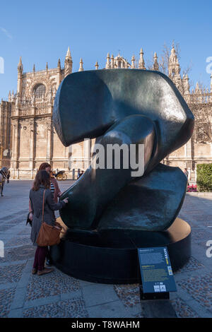 Sculpture named 'Locking Piece' of Henry Moore (1898-1986), one of the great masters of modern sculpture, is shown in touring exhibition of Moore's work in Seville. It was located among Seville's Historical buildings, declared World Heritage Site by UNESCO. Stock Photo