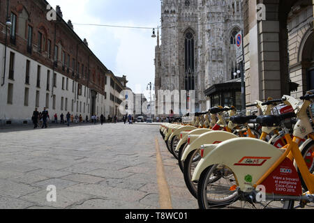 Milan/Italy - June 1, 2015: Rental citybikes branded EXPO Milano 2015 are parked at the station near Duomo of Milan. Stock Photo