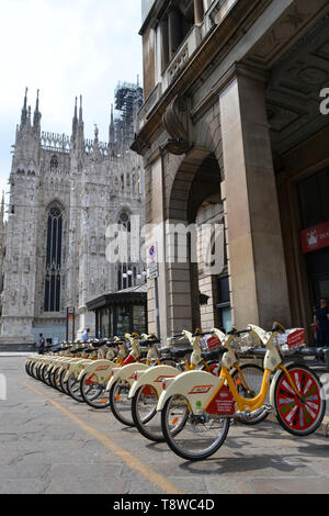 Milan/Italy - June 1, 2015: Rental citybikes branded EXPO Milano 2015 are parked at the bicycles station near Duomo of Milan. Stock Photo