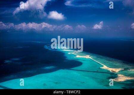 This unique image shows the Maldives photographed from a plane from above. You can see the atolls in the sea well. Stock Photo