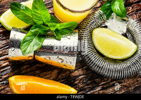 Orange cocktail with lime slice and ice.Glass of orange drink Stock Photo