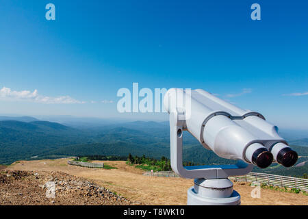 Coin operated electronic binoculars for tourists on a mountain summer landscape Stock Photo