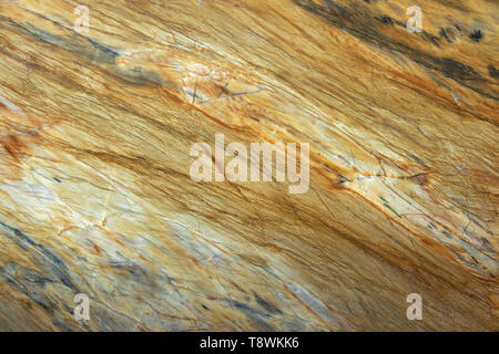 Natural stone, marble texture in yellow color with gray stains and stripes. Stock Photo