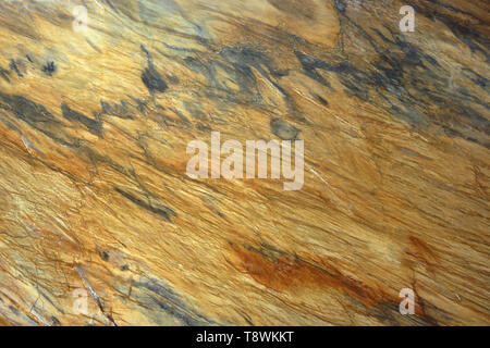 Natural stone, marble texture of yellow color with gray stains and stripes, beautiful pattern. Stock Photo
