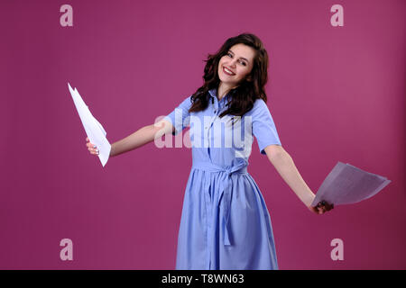Attractive smiling business woman with documents in her hands. Stock Photo