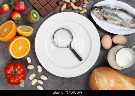 Allergy food concept. Foods, fruits, vegetables, empty plate on grey background Stock Photo