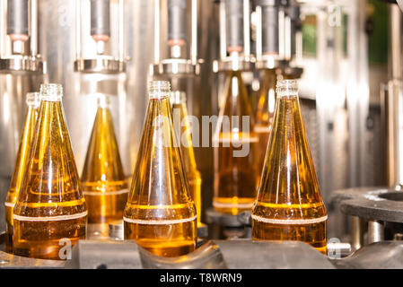 Bottling of fruit juice in autumn. Apple juice in glass bottles Stock Photo