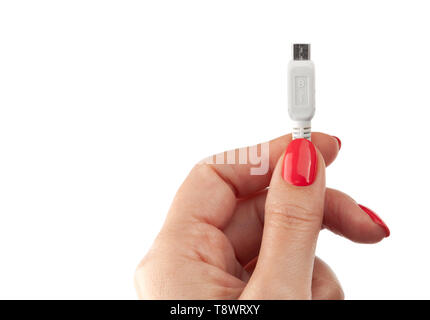 Hand holding USB cable. Female hand holding charging cable. Isolated on white background Stock Photo