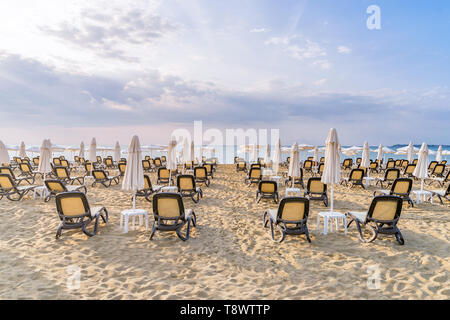 Chairs and umbrellas on a beautiful beach at sunrise in Sunny Beach on the Black Sea coast of Bulgaria. Stock Photo