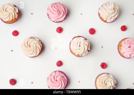 Delicious cupcakes on white background, flat lay Stock Photo