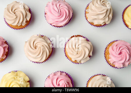 Delicious cupcakes on white background, flat lay Stock Photo
