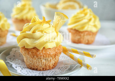 Plate with delicious lemon cupcake on table Stock Photo