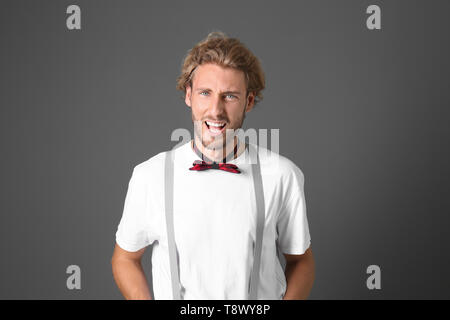 Portrait of handsome emotional man on grey background Stock Photo