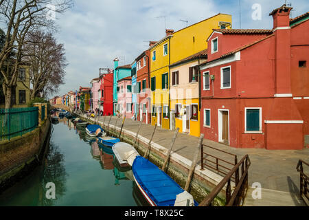 Colorfully painted houses on the island Burano, located along a water canal Stock Photo