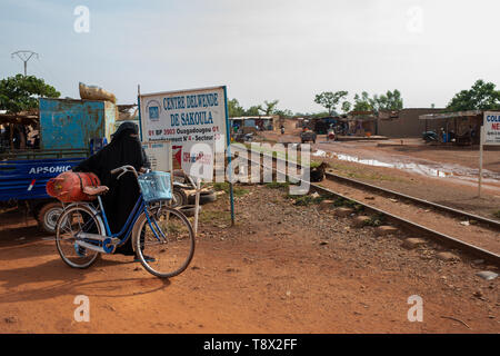 Velated Muslim woman in the Ouagadougou streets, capital of Burkina Faso, one of the most poor country of Africa Stock Photo