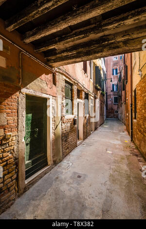Narrow street leading through the ailing brick houses of the so-called 'Floating city' Stock Photo