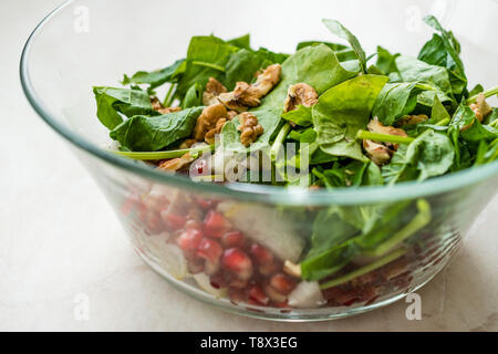 Fresh Walnut Salad with Pomegranate and Pear Slices in Glass Bowl. Ready to Make. Organic Food. Stock Photo