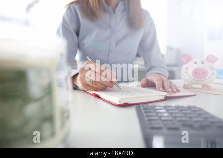 Female hand hold silver pen make notes Stock Photo