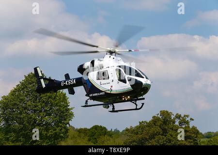 Tenterden, Kent, UK. 15th May, 2019. A Kent Surrey Sussex air ambulance has been dispatched to an incident in the town centre. Medical staff are at scene. The emergency has taken place at the Old Dairy Brewery just off the high street in the town centre. The MD902 Explorer helicopter takes off into the air. Photo Credit: Paul Lawrenson /Alamy Live News Stock Photo