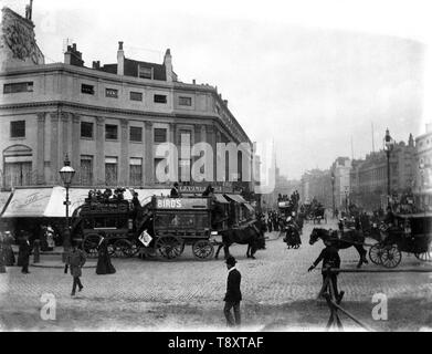 Oxford Circus Victorian London street scene of horse drawn buses and other vehicles and people going about their daily business, with a back drop of canopied shops and All Souls Church in the distance. c1900 Photo from the wholly-owned original glass plate negative collection by Tony Henshaw Stock Photo