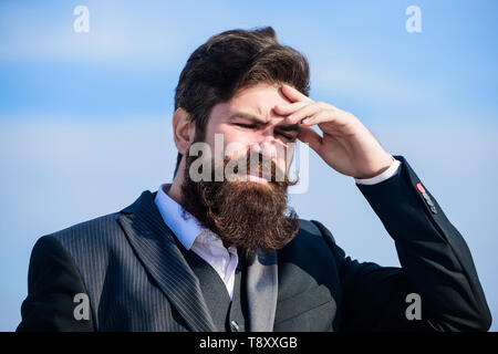 Guy suffer headache stressful day. Stressful business. Pain and migraine. Frustration and disappointment. Unforgivable mistake. Business failure. Man bearded stressful painful face sky background. Stock Photo