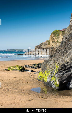 Evening light over rocks exposed at low tide on Great Western Beach in Newquay in Cornwall. Stock Photo