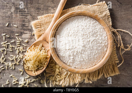 White rice flour in a bowl on wooden table. Top view Stock Photo