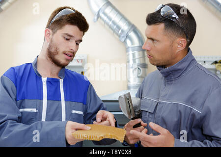 two engineers are talking and pointing to the problem Stock Photo