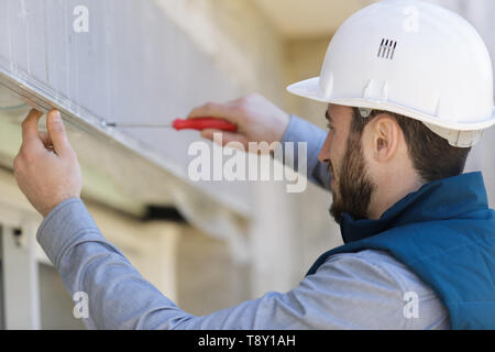male hand screwing a screw Stock Photo