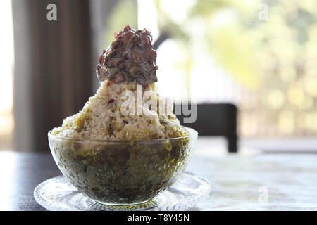 Traditional Japanese Dessert , A Bowl of Red Bean Sweet with red ice on wood pattern Stock Photo