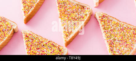 Traditional Australian fairy bread pattern on pink background. Panoramic view Stock Photo