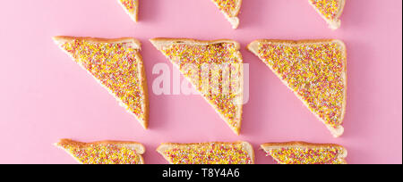 Traditional Australian fairy bread pattern on pink background. Panoramic view Stock Photo