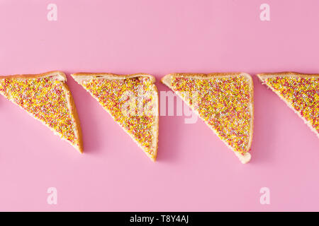 Traditional Australian fairy bread pattern on pink background Stock Photo