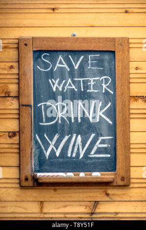 Handwritten Save Water, Drink Wine in Chalk on a Menu Board Stock Photo